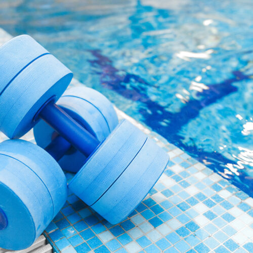 dumbbells equipment for aqua aerobics sport near swimming pool