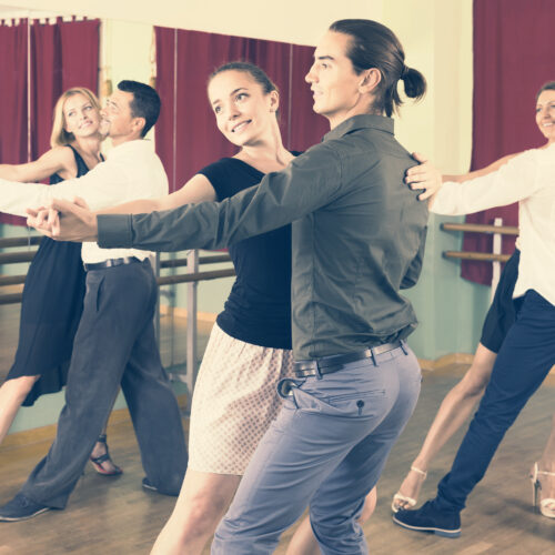 russian men and women enjoying of tango in class